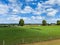 View on typical dutch rural flat landscape along river Maas with cycling track near Nijmegen, Netherlands