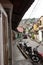 View of typical narrow street of El hatillo, people walking on the sidewalk, motorcycles one after another parked and in front on