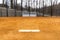 View of typical nondescript high school softball clay infield looking from pitching rubber