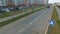 View of typical Russian street in summer with new buildings, road, cars, footpaths and walking people. Scene. Everyday