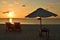 View of umbrella and sunbeds facing the Indian Ocean and the beautiful sunset