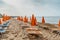 View of umbrellas,deck chairs on sandy beach and sea.Empty beach waiting for tourists, Sicily, Italy.Travel agency concept banner.