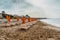 View of umbrellas,deck chairs on sandy beach and sea.Empty beach waiting for tourists, Sicily, Italy.Travel agency concept banner.