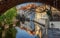 View under the arch of the Charles Bridge on the Certovka water wheel. Prague.