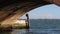 View under a stone bridge to the lagoon of Venice, Italy