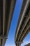 View Underneath a Large Bridge Highway on a Sunny Day with Blue Sky