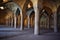 View of the unique interior architecture of Vakil Mosque with large columns and beautiful Iranian tiles, Shiraz, Iran.