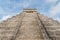 View up the main steps of El Castillo (Temple of Kukulkan) in Chichen Itza with blue sky