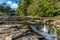 A view of the upper falls and old arch bridge at Stainforth Force, Yorkshire