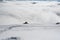 A view of the valley from the edge of a snowy slope