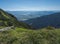 View on valley of Liptovsky Mikulas with liptovska mara lake from meadow with blooming pink Plantago flowers, Western