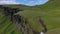 View of the valley with a river and a cliff with a waterfall