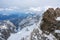 View in the valley from the Zugspitze, the highest mountain of Germany in the snow covered Bavarian Alps, cloudy sky, copy space