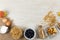 View of a variety of nuts and muesli, bowls of dried and fruits and eggs on wooden surface