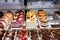 View of various assortment of cakes on the stand in the bakery