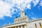 View on VDNKh central pavilion. USSR Empire style white building with traditional soviet golden elements, columns