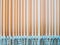 View of the vertical slats of peach-colored blinds. Parallel stripes