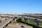 A view of a very busy interstate highway overpass exchange with multiple lanes of freeway traffic and a bright blue sky