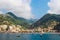 View of the vibrant town, hills and harbour of & x27;Amalfi& x27; from a boat, the Amalfi coast, Italy.