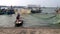 View of Vietnamese fishermen and their boat aproaching to the dockside, Da Nang