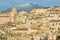 View of village and belltower on background Etna