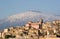 View of village and belltower on background Etna