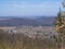 View on village in brdy in czech republic with trees, buildings and hills, early spring, blue sk