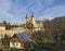 View on Village Hejnice with cottages, creek and Baroque Basilica church of the Visitation Virgin Mary in spring, golden