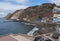 view of village Puerto de Sardina del Norte with sand beach, coastal cliffs, marina and colorful houses. Grand Canaria