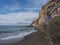 View of village Puerto de Sardina del Norte with sand beach, coastal cliffs, marina and colorful houses. Grand Canaria, Canary