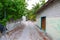 View of village street of one of Maldive Islands. Green trees and old buildings. Poor environment. Local society.