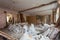 View of the vintage room with fretwork on the ceiling of the apartment and retro chandelier during under renovation, remodeling