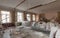 View of the vintage room with fretwork on the ceiling of the apartment and retro chandelier during under renovation, remodeling