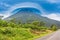 View at the volcano Arenal peak covered in clouds, Costa Rica.