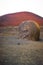 View of a volcano with a big stone in front