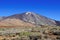 View of volcano Mount Teide Teide Peak, surroundings with hardened lava and treeless mountain vegetation.