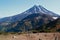 View of the volcano, the traveler on the bench looking at the mountain