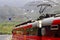 View of Voss mountain train stopped at Myrdal train station with snowy peaks on backgound, Norway