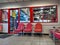 View of the waiting area inside a Discount Tire shop with a window into the maintenance area