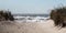 View of walking down the beach with a rough Atlantic Ocean