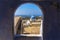 A view through a wall portal over the village of Pyrgos, Santorini