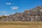 View of the Wall on the Sacsayhuaman Inca Archaeological Site and the Statue of Christ near Cusco, Peru