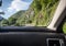 View on warning of landslide sign on road from inside of car