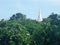 View Wat Atsadang Nimit through green garden and mountain on Sichang Island , Chonburi , Thailand