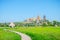 View of Wat Tham Sua with rice field and blue sky on background, Tiger cave temple most popular temple in Kanchanaburi , Thailand