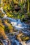 A view of water cascading over waterfalls at Lumsdale on Bentley Brook, Derbyshire, UK