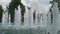 View of water jets in fountain in center of city on sunny day