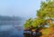 View water river tree in mist, River and fishing boat in mist rural countryside