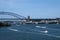 View from water of of Sydney Harbour Bridge and city on ramp with Walsh Bay wharves