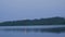 View from water to full moon reflected in lake